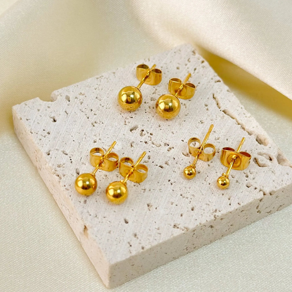 Stainless steel ball stud earrings showing 3mm, 4mm, 5mm, and 6mm sizes with gold and silver finishes