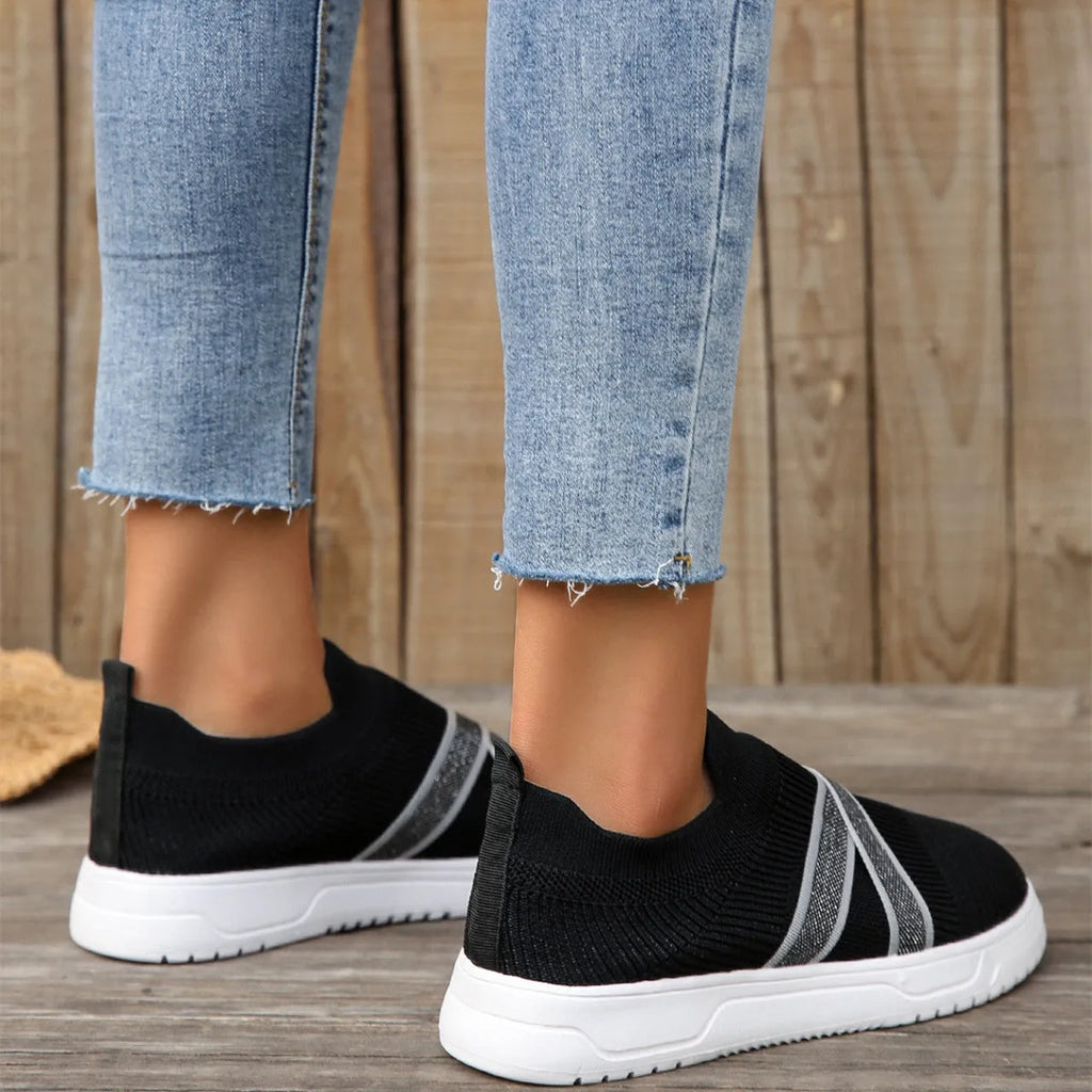 Black women's flat knit mesh shoes with tassel detail and rubber sole