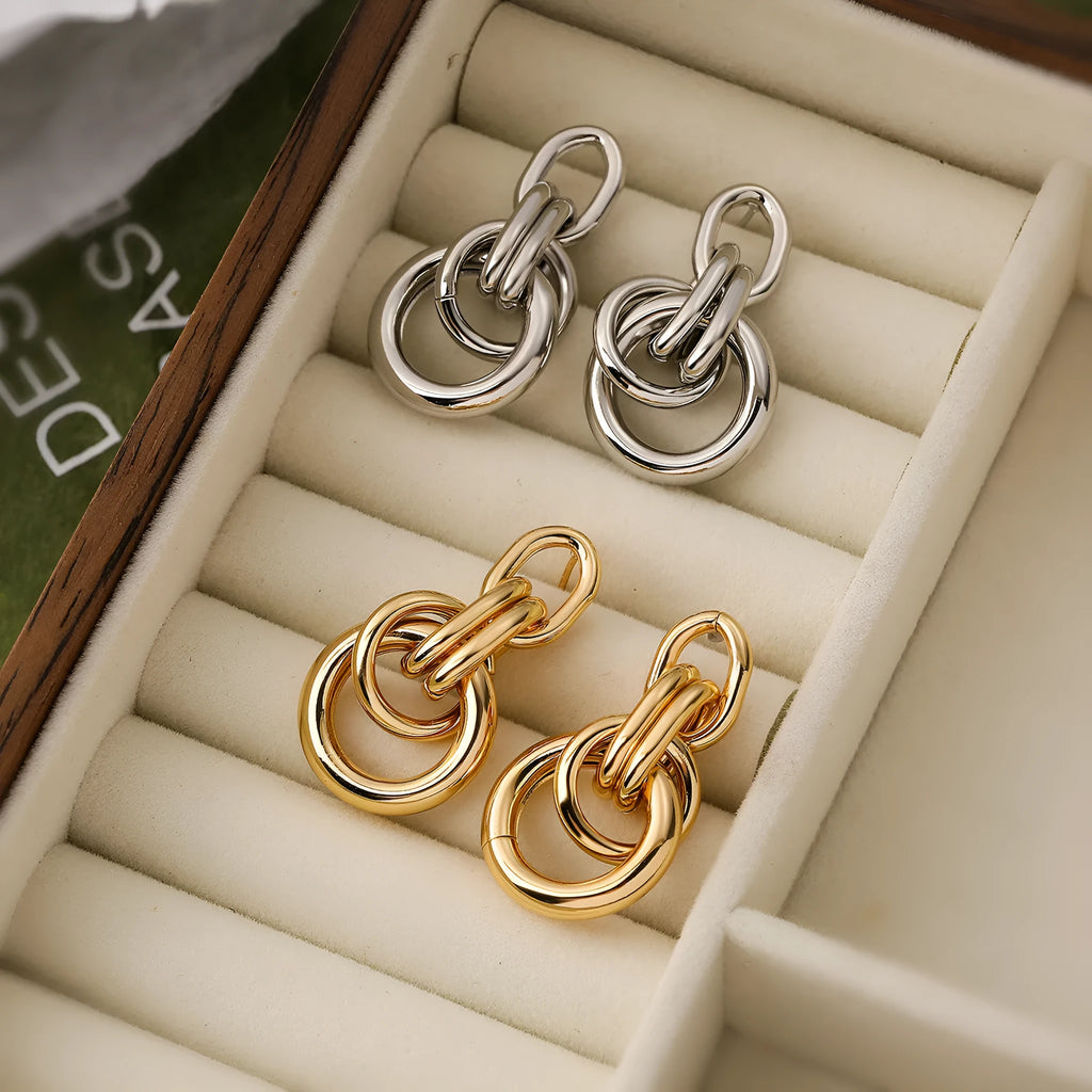 Geometric irregular-shaped copper earrings for women with a real gold colour finish.