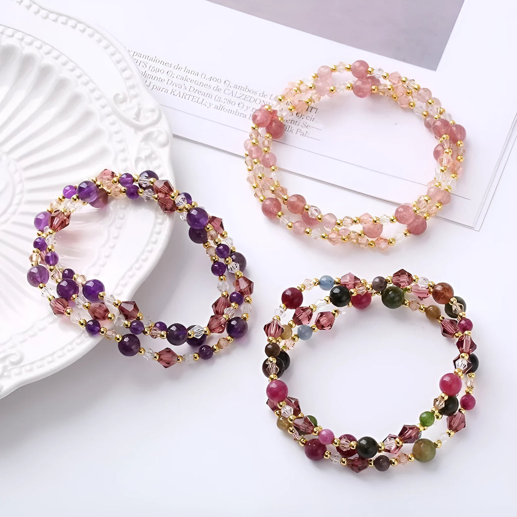 Women's three-ring crystal bracelet with tourmaline, strawberry quartz, and amethyst beads on adjustable cord.