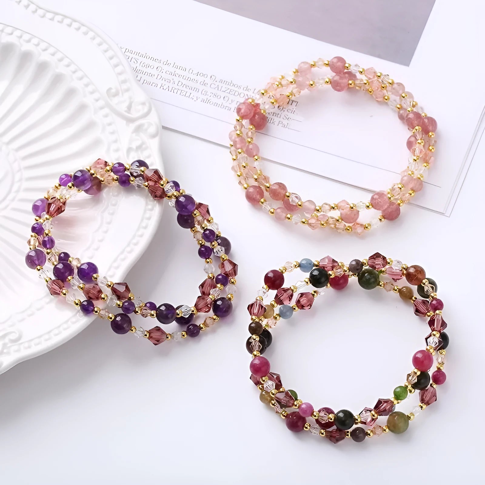 Women's three-ring crystal bracelet with tourmaline, strawberry quartz, and amethyst beads on adjustable cord.