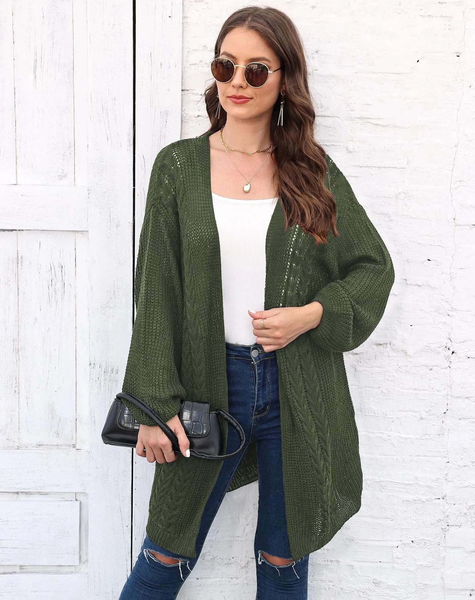 Women's loose brown acrylic sweater coat hanging on a hanger