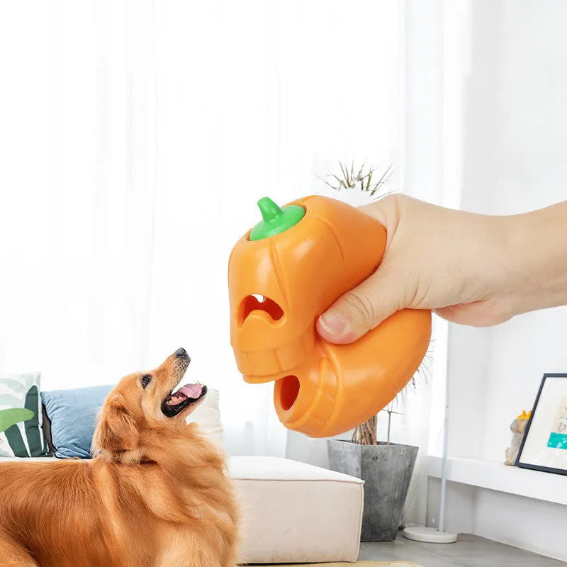 Orange Halloween pumpkin shaped rubber dog toy with a treat-dispensing funnel.