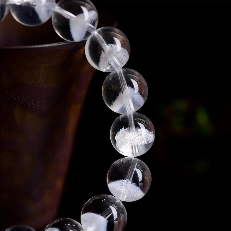 White crystal pyramid bracelet with natural ghost charm and Ruyi symbol detail on wrist