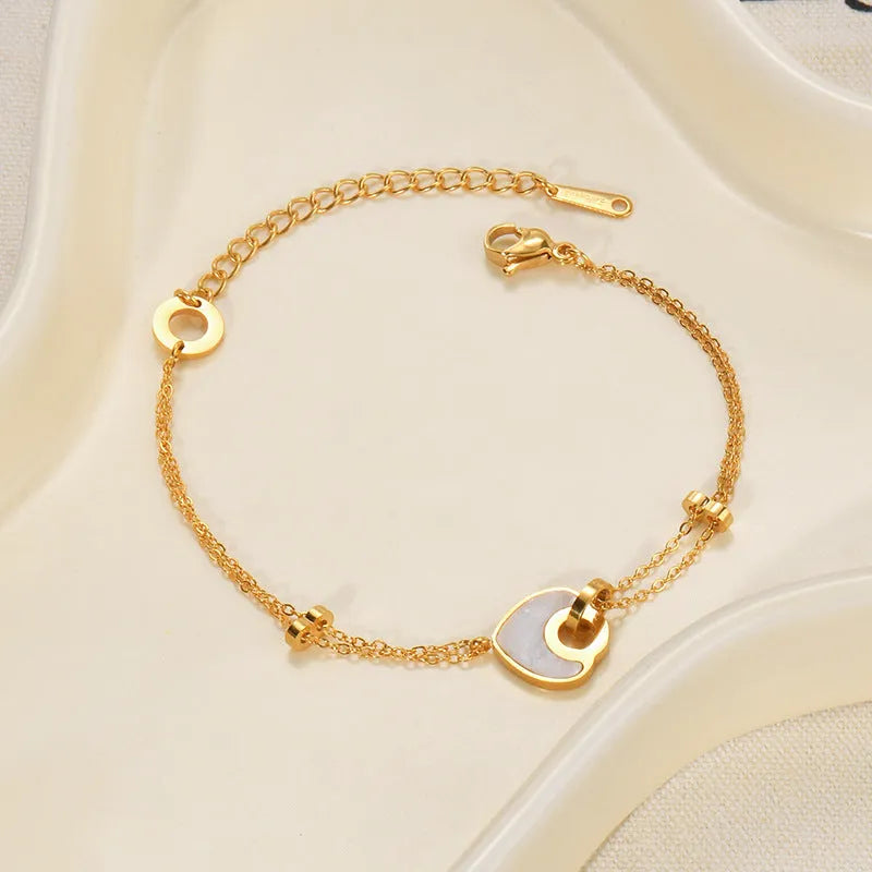 Women's stainless steel bracelet with a double-layered resin heart shape and electroplated finish.