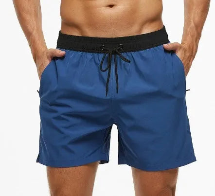 Men's blue fitness shorts with stitching waist detail, drawstring, and multiple pockets for gym workouts