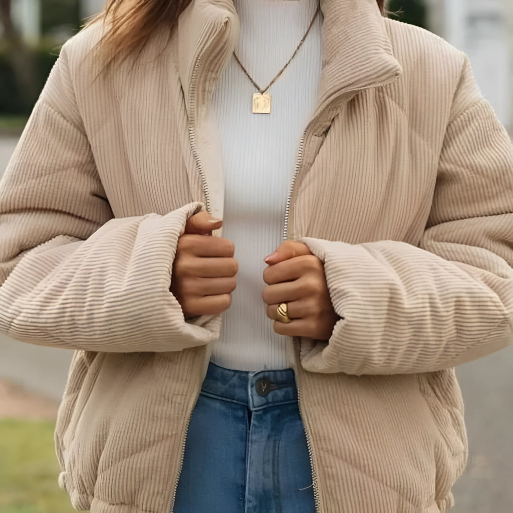 Apricot women's corduroy zip-up jacket with a stand collar, shown on a model.