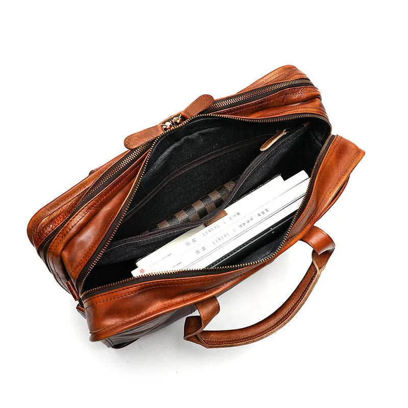 Large brown leather men's briefcase showing multiple internal compartments and organisation pockets