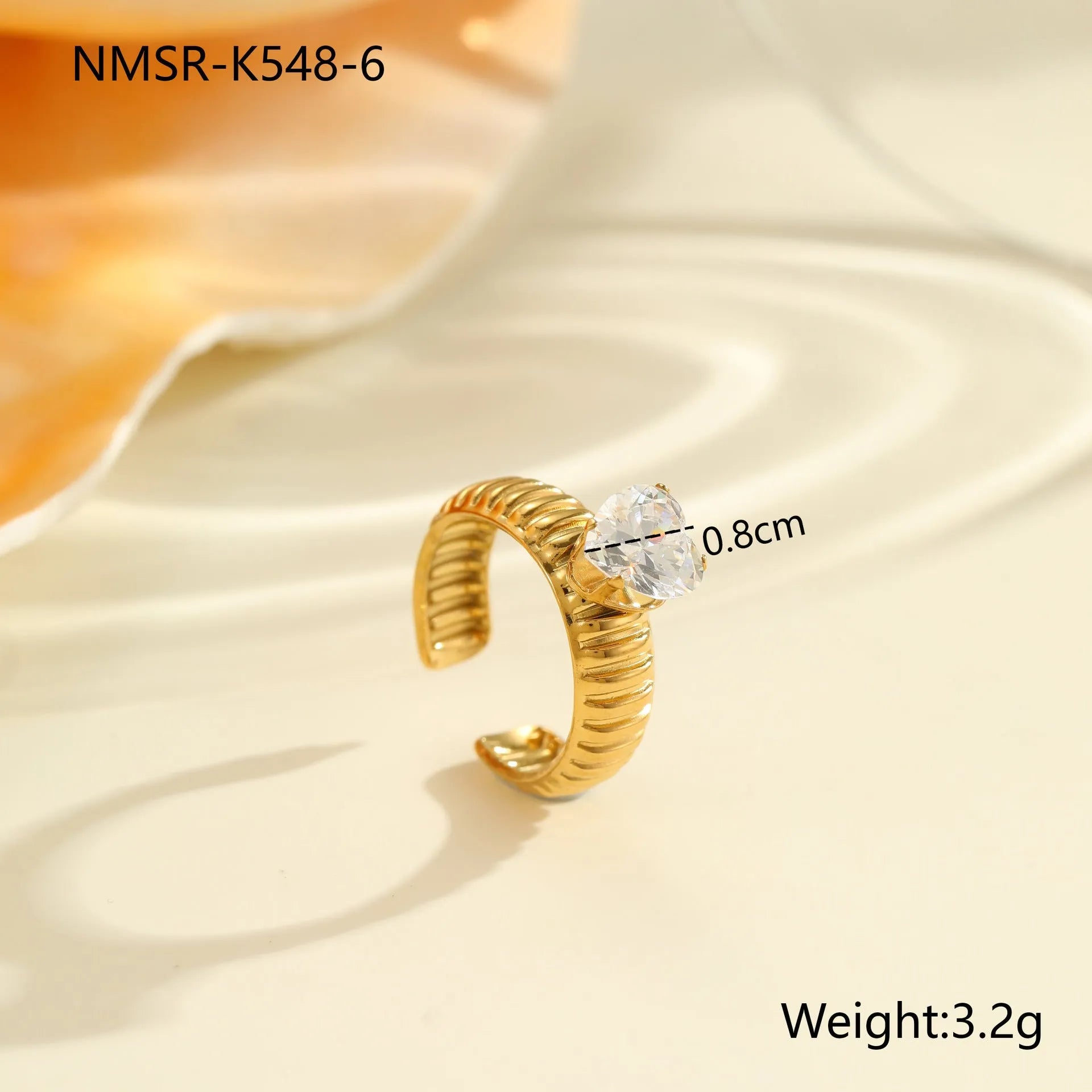 Gold-coloured stainless steel open ring with zircon stones in a geometric heart design.