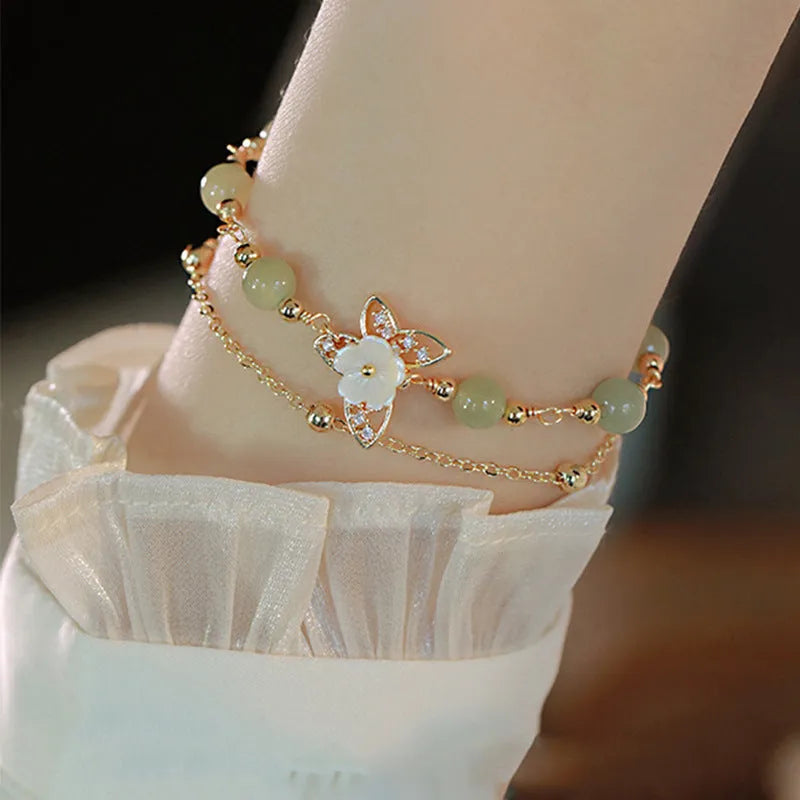Yellow gold electroplated copper bracelet with shell flower butterfly and Hetian jade design for women