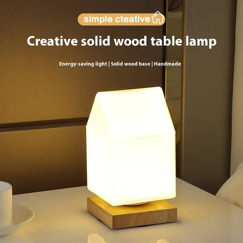 Nordic solid wood USB table lamp in a white geometric shape on a wooden surface.