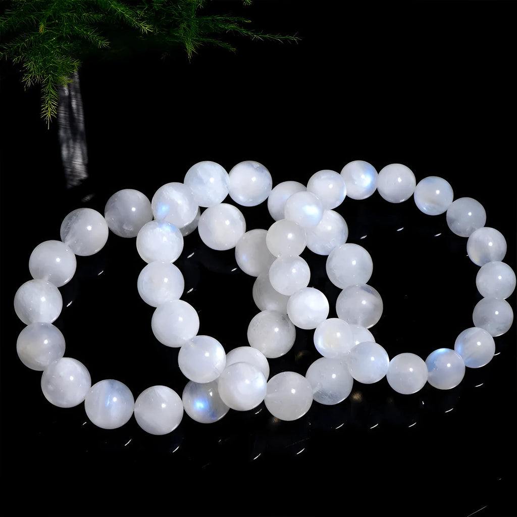 Natural blue moonlight moonstone round bead bracelet showing polished geometric beads on wrist