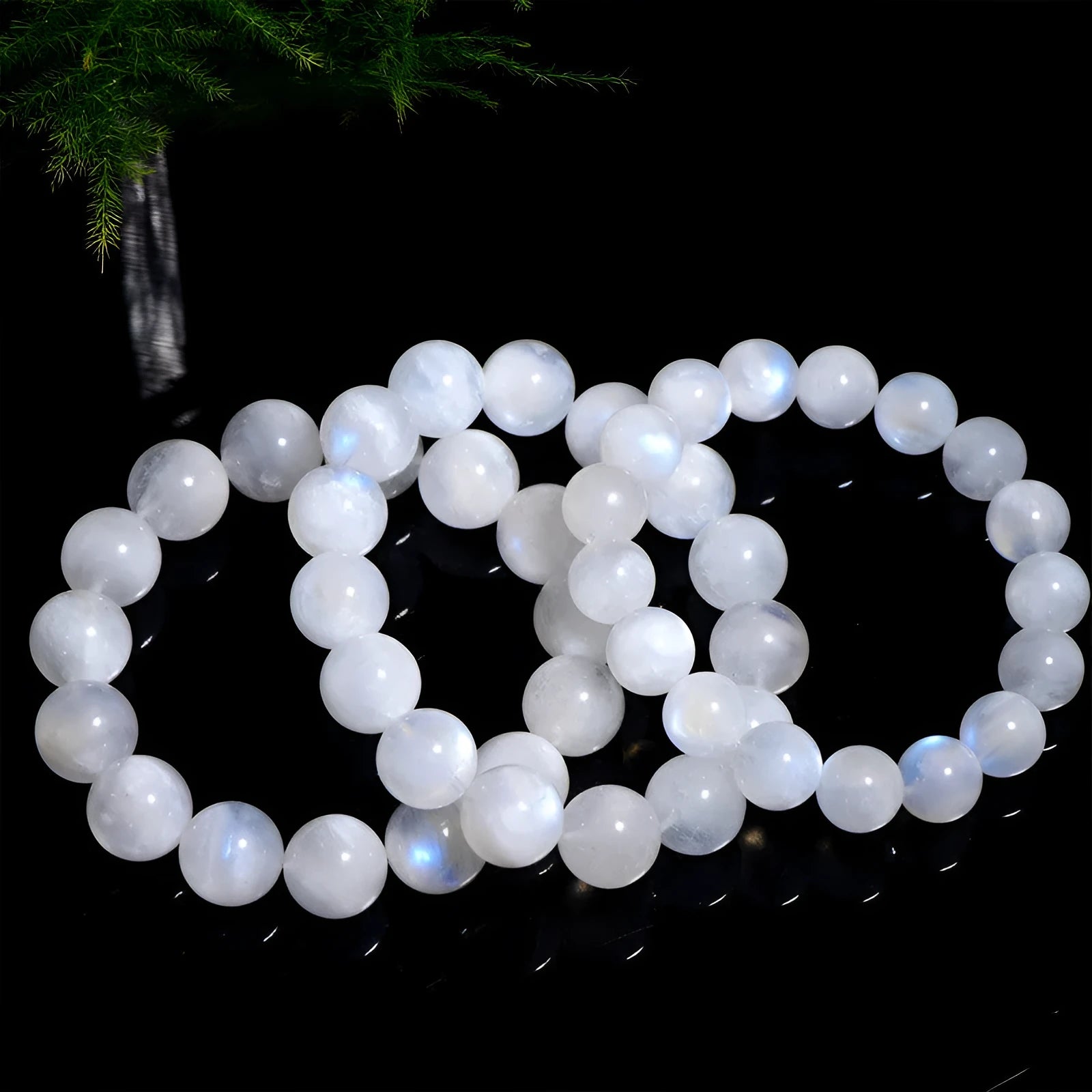 Natural blue moonlight moonstone round bead bracelet showing polished geometric beads on wrist