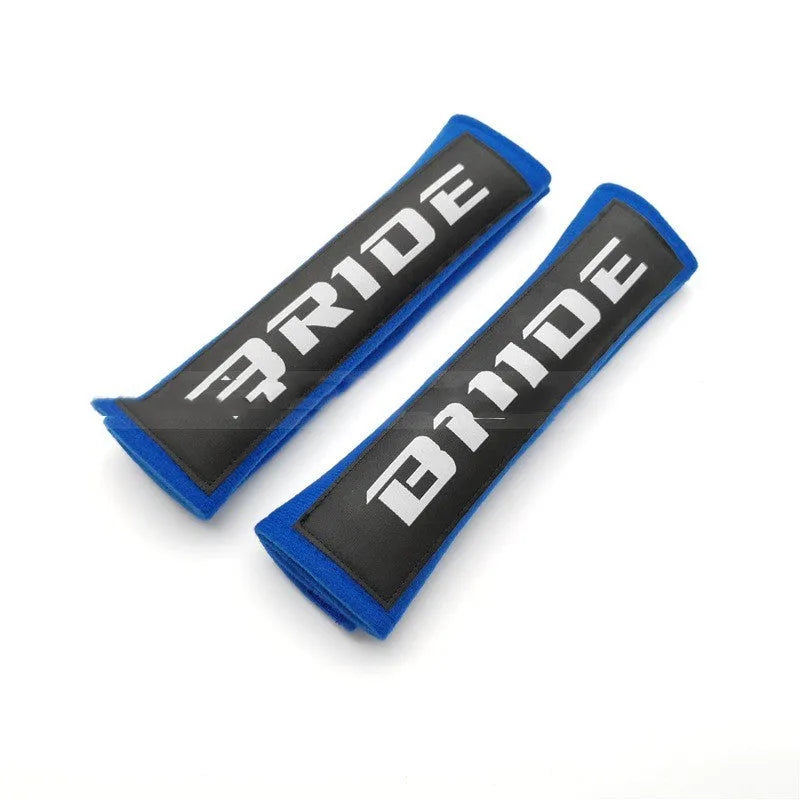 Pair of black car seatbelt shoulder pads with embroidered texture, showing dimensions.