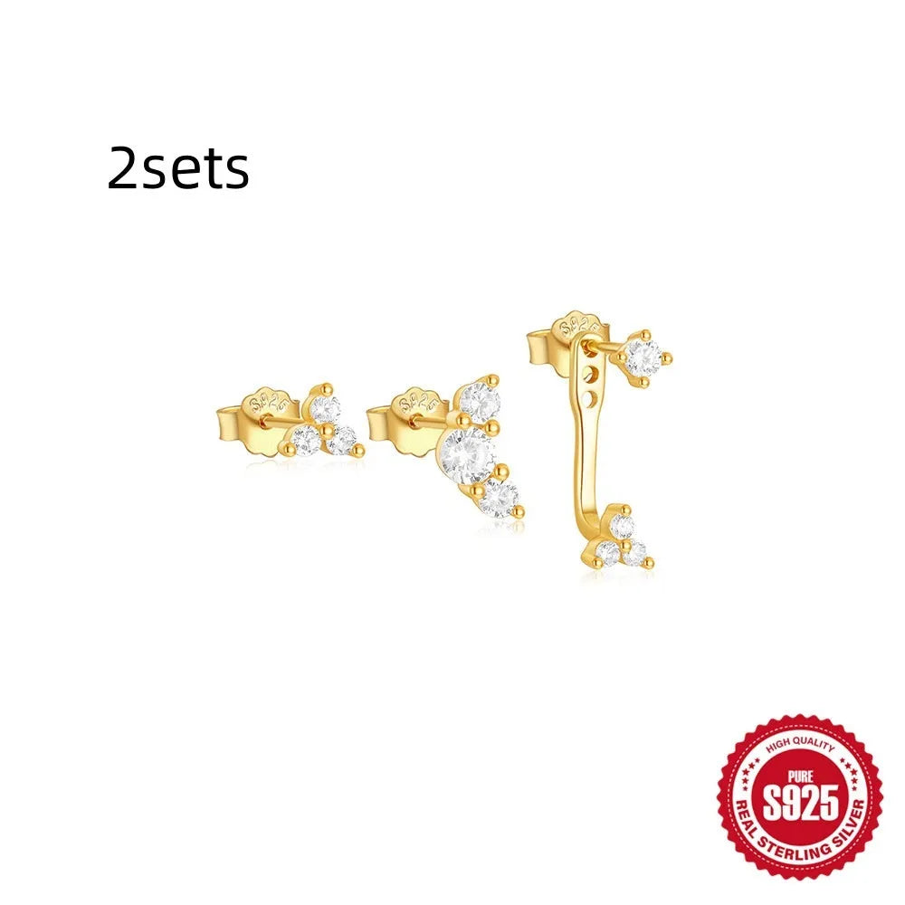 Set of three S925 sterling silver geometric tassel ear studs with zircon details on a plain background.