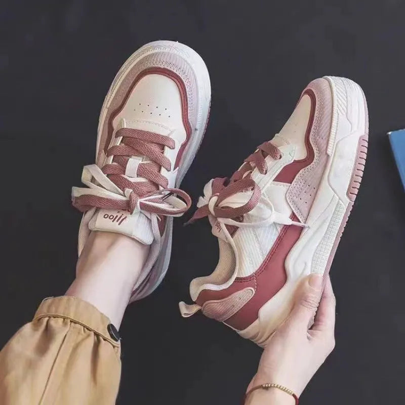 Women's pink and white low-top sneaker with rubber sole for height increasing