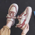 Women's pink and white low-top sneaker with rubber sole for height increasing
