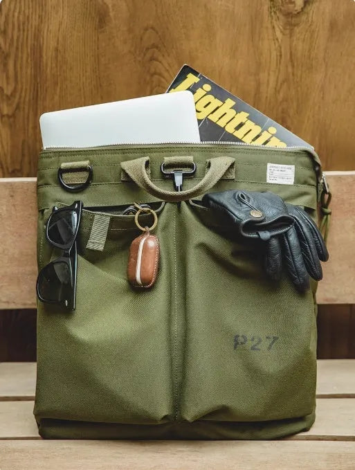 Canvas crossbody messenger bag in military green with shoulder strap showing vertical square shape and zipper closure