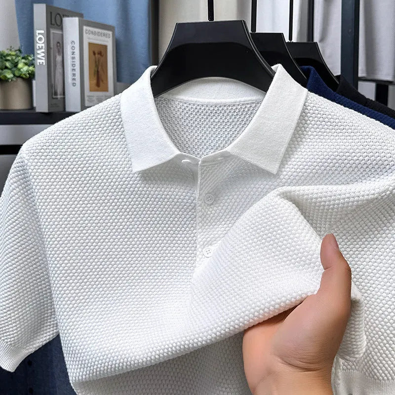 Man wearing a loose fit short sleeve cotton sweater in grey, showing the pullover style and relaxed silhouette.