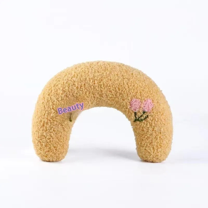 Blue U-shaped cloth pet sleeping mat for cats with neck support pillow in a question mark design.