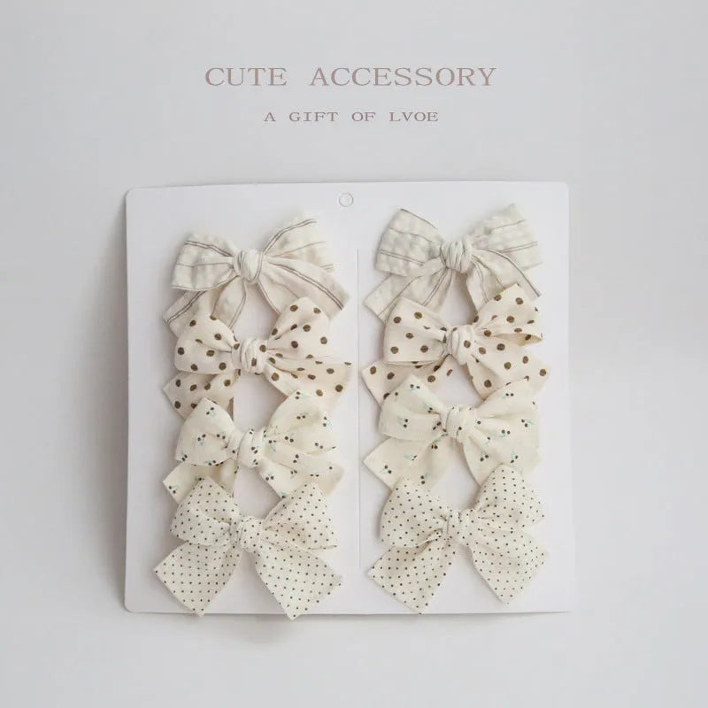 Children's fabric dovetail bow hair clips in eight pattern options