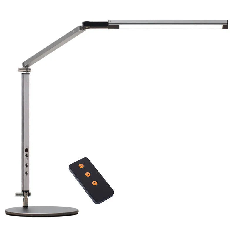 Folding aluminium desk lamp with a metal clip, shown in dazzling black, attached to a desk edge.