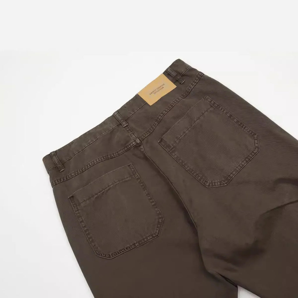 Men's brown loose straight-leg trousers with high waist and wide leg opening on a hanger