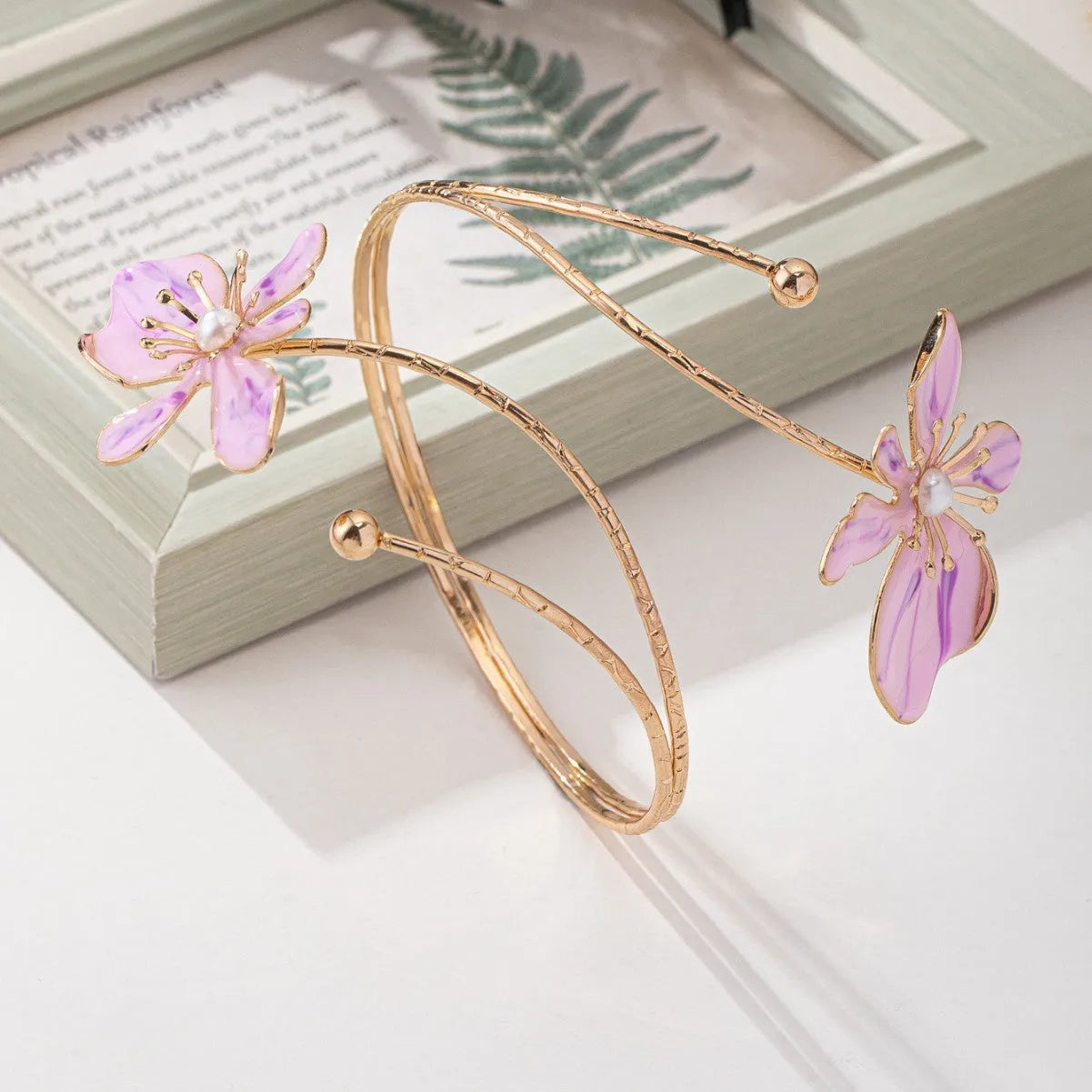 Pink alloy armband with hollow line pattern design on wrist
