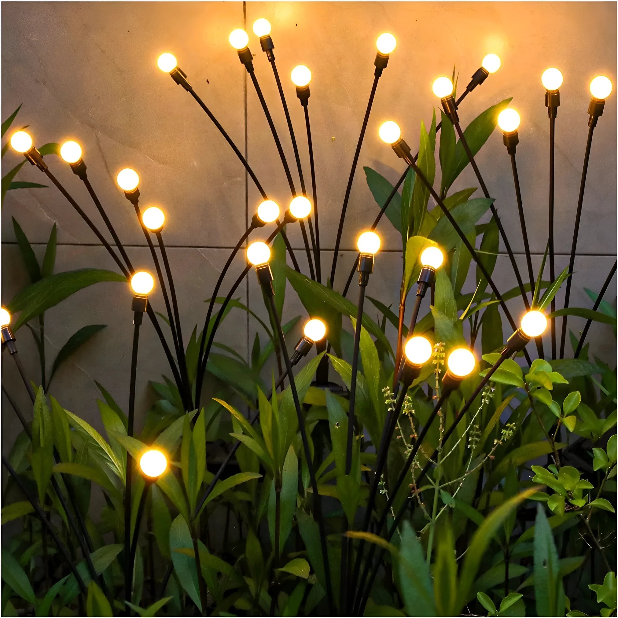 Solar-powered LED garden ground light with stainless steel spike inserted in lawn showing automatic dusk-to-dawn operation