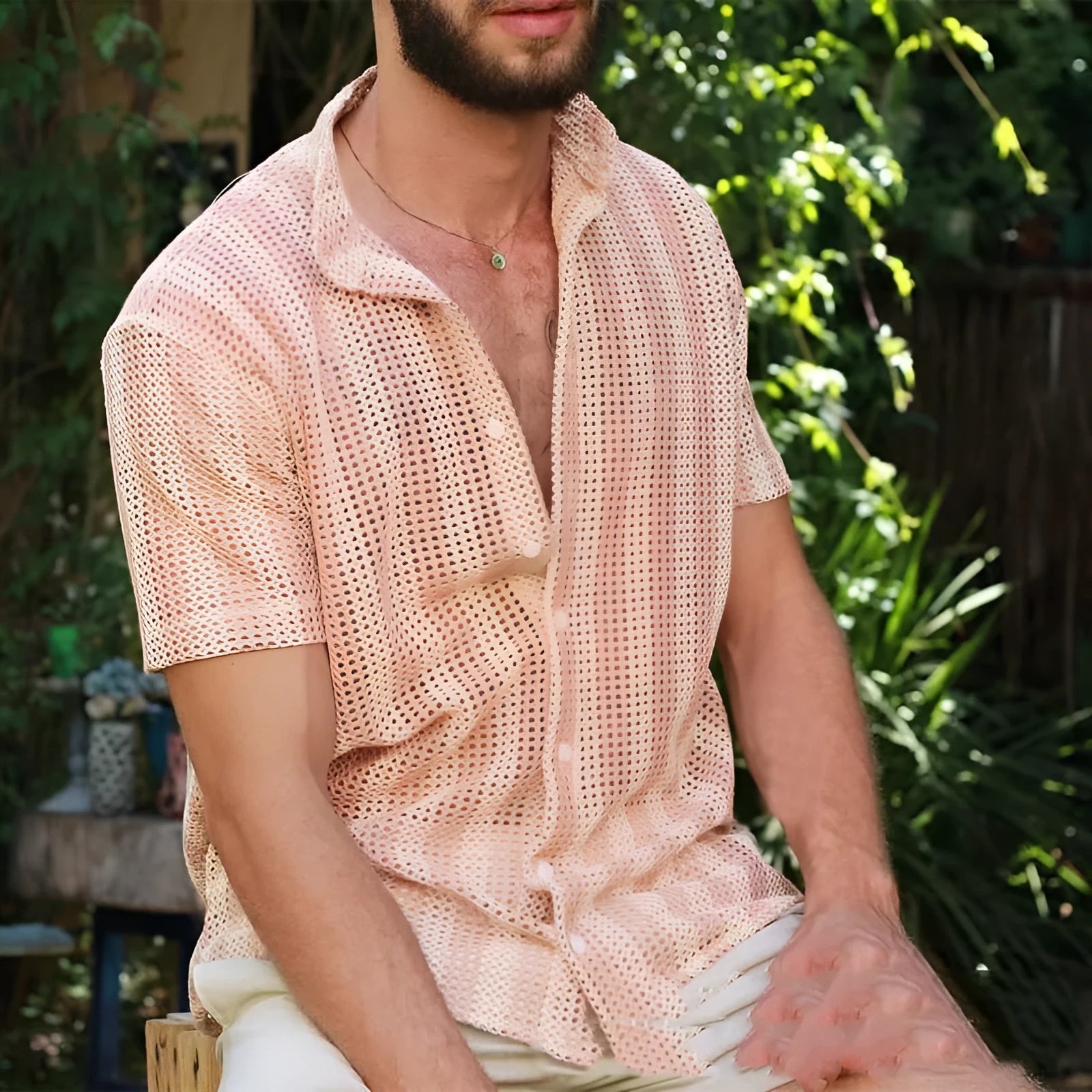 Pink men's loose-fit waffle knit short sleeve cardigan shirt on a hanger