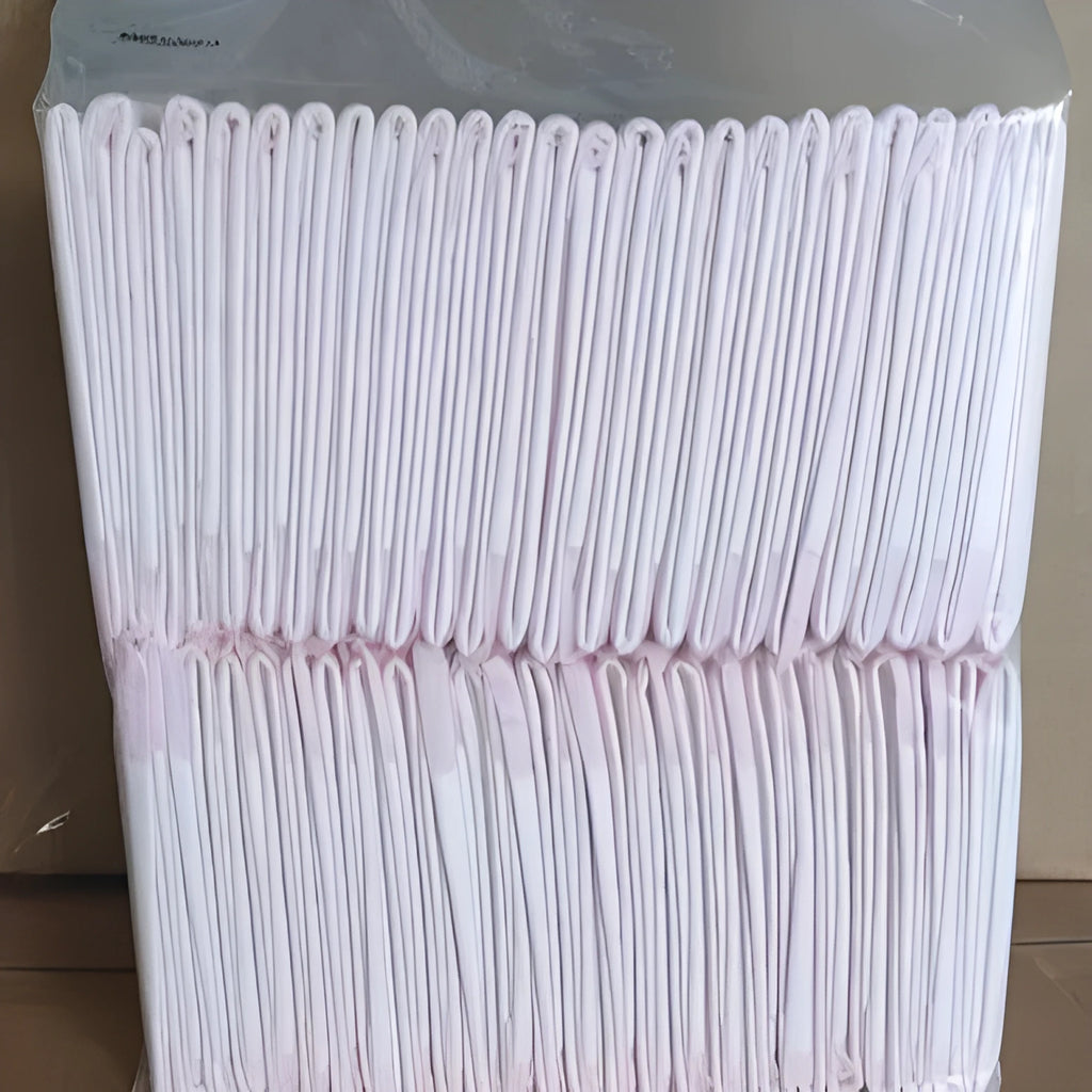 Large 60x60cm disposable pet urine pad for dog house training on a floor