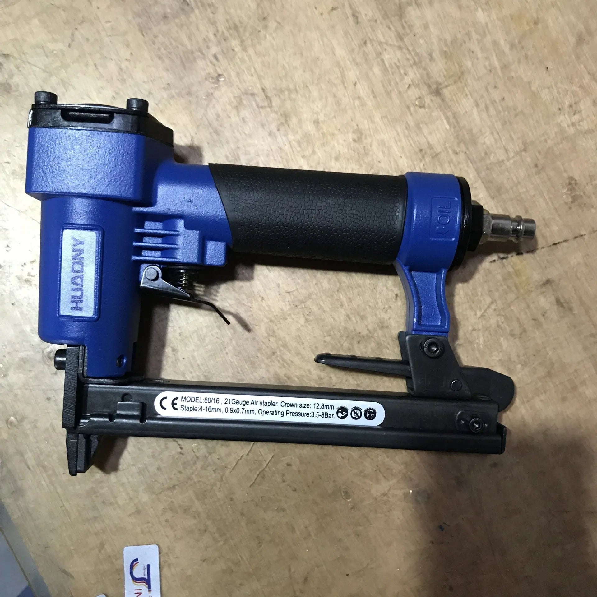Blue and yellow U-type pneumatic strip nail gun for decoration and upholstery work.