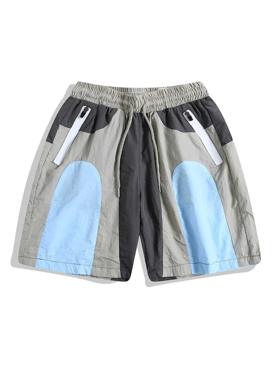 Blue men's patchwork loose-fit quick-drying shorts laid flat, showing straight-leg cut and tether fly.