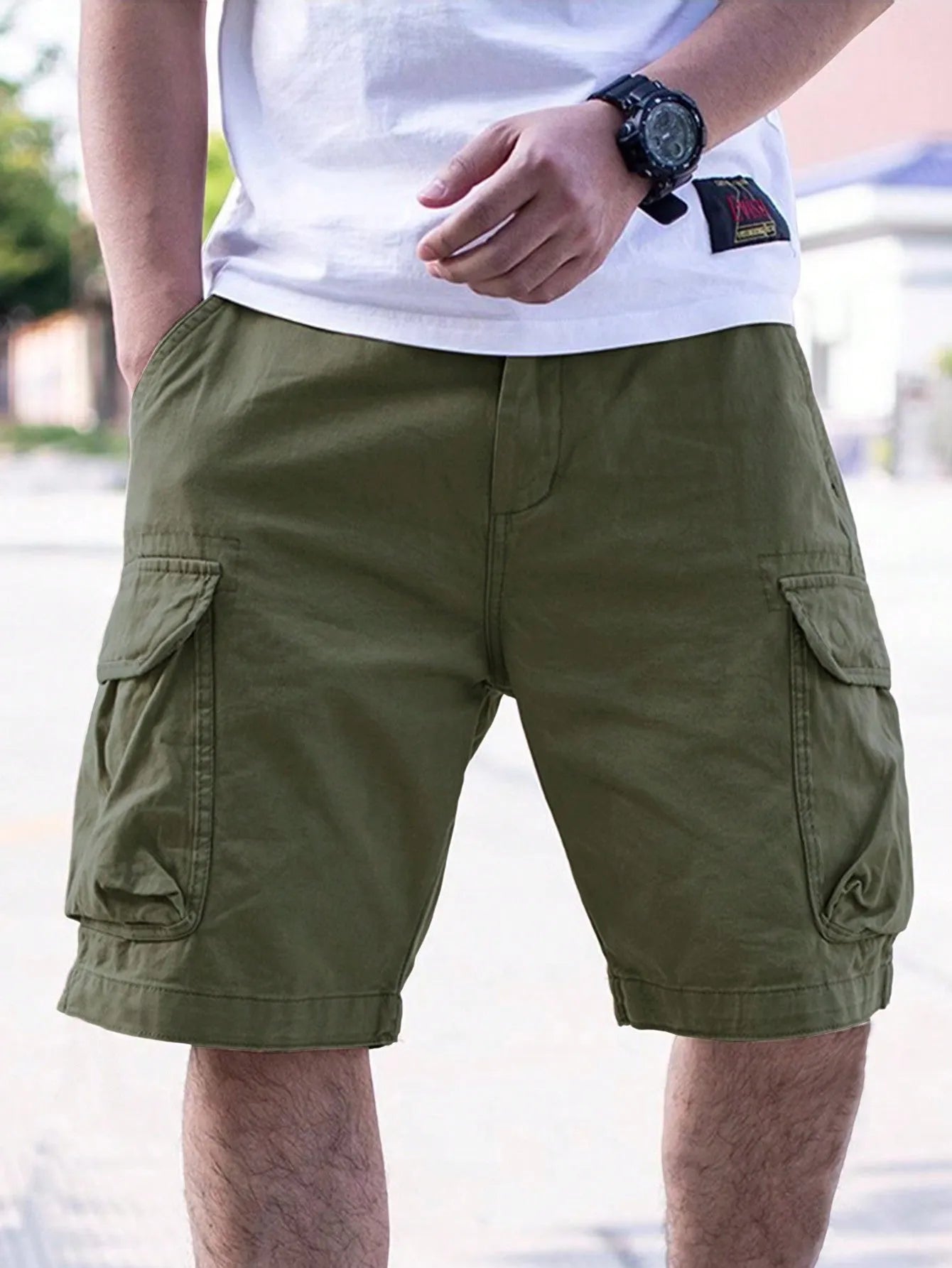 Man wearing loose-fit army green cotton blend workwear shorts with an elastic waist.