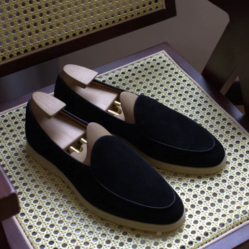 Men's brown genuine leather flat loafers with a low cut and TPR sole on a light background.