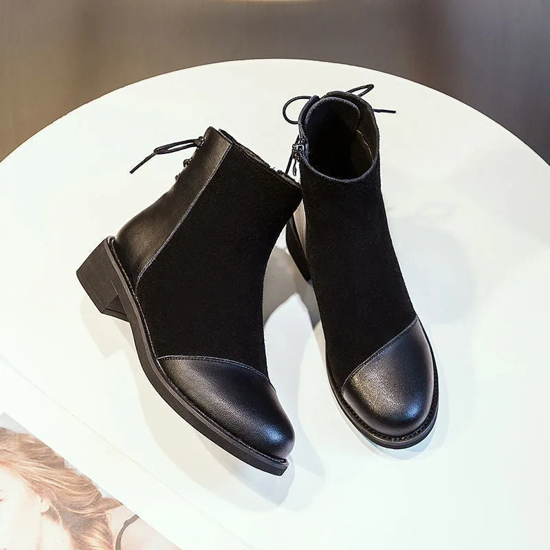 Women's black knee-high Martin boots with side zip closure and bow detailing