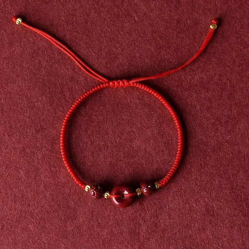 Cinnabar safety buckle bracelet with heart-shaped pendant on adjustable rope cord