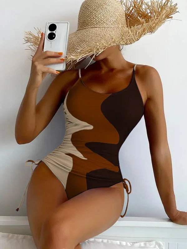 Women's sleeveless one-piece swimsuit in blue with backless design and striped pattern