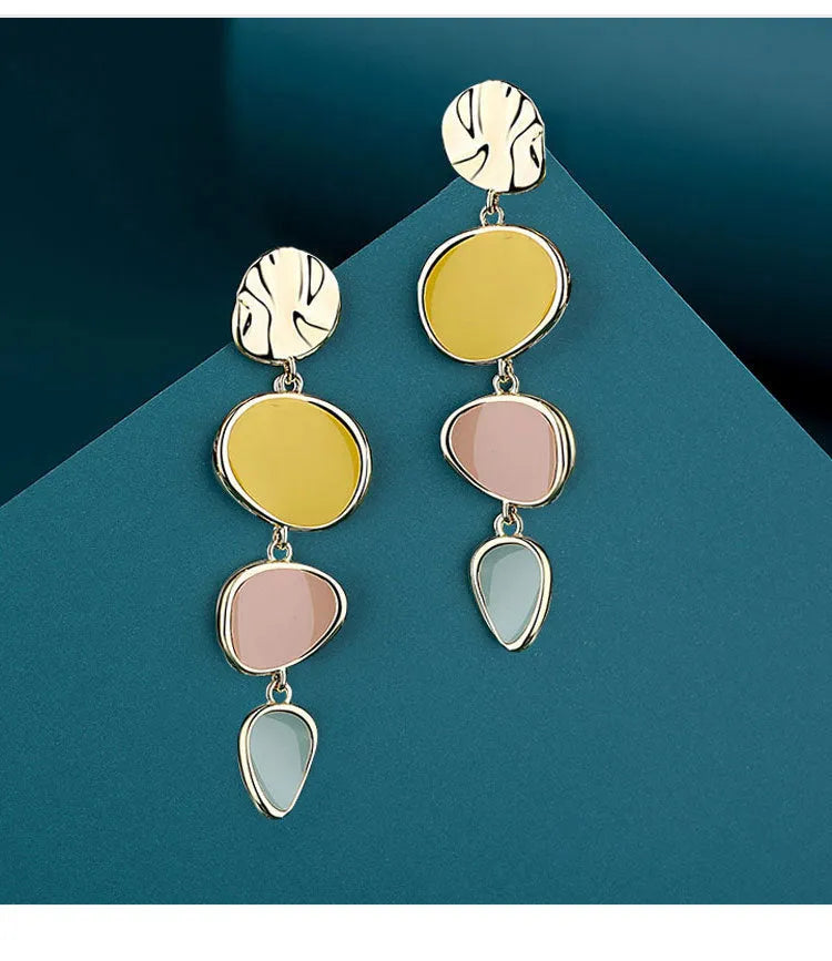 A pair of disc-shaped alloy earrings with a Morandi three-colour dripping oil finish on a sterling silver needle post.