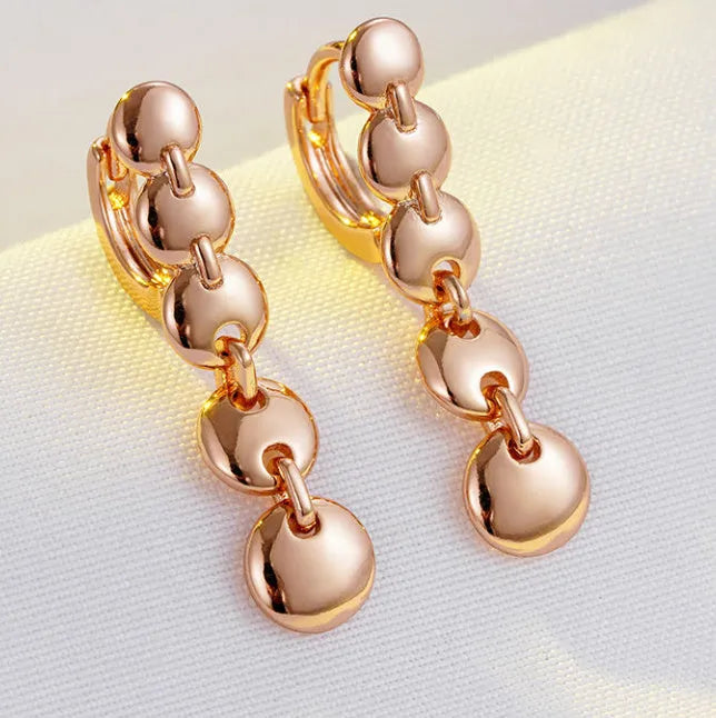 Gold-coloured woven copper round circle drop earrings with retro design.
