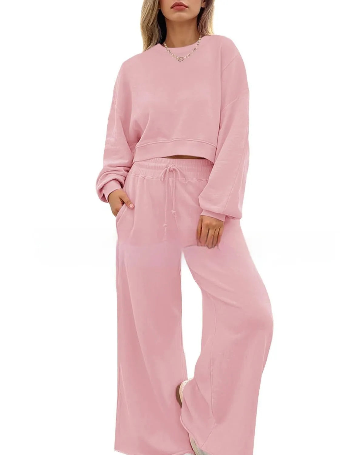 Women's solid colour long sleeve top and trousers two-piece set in polyester fabric.