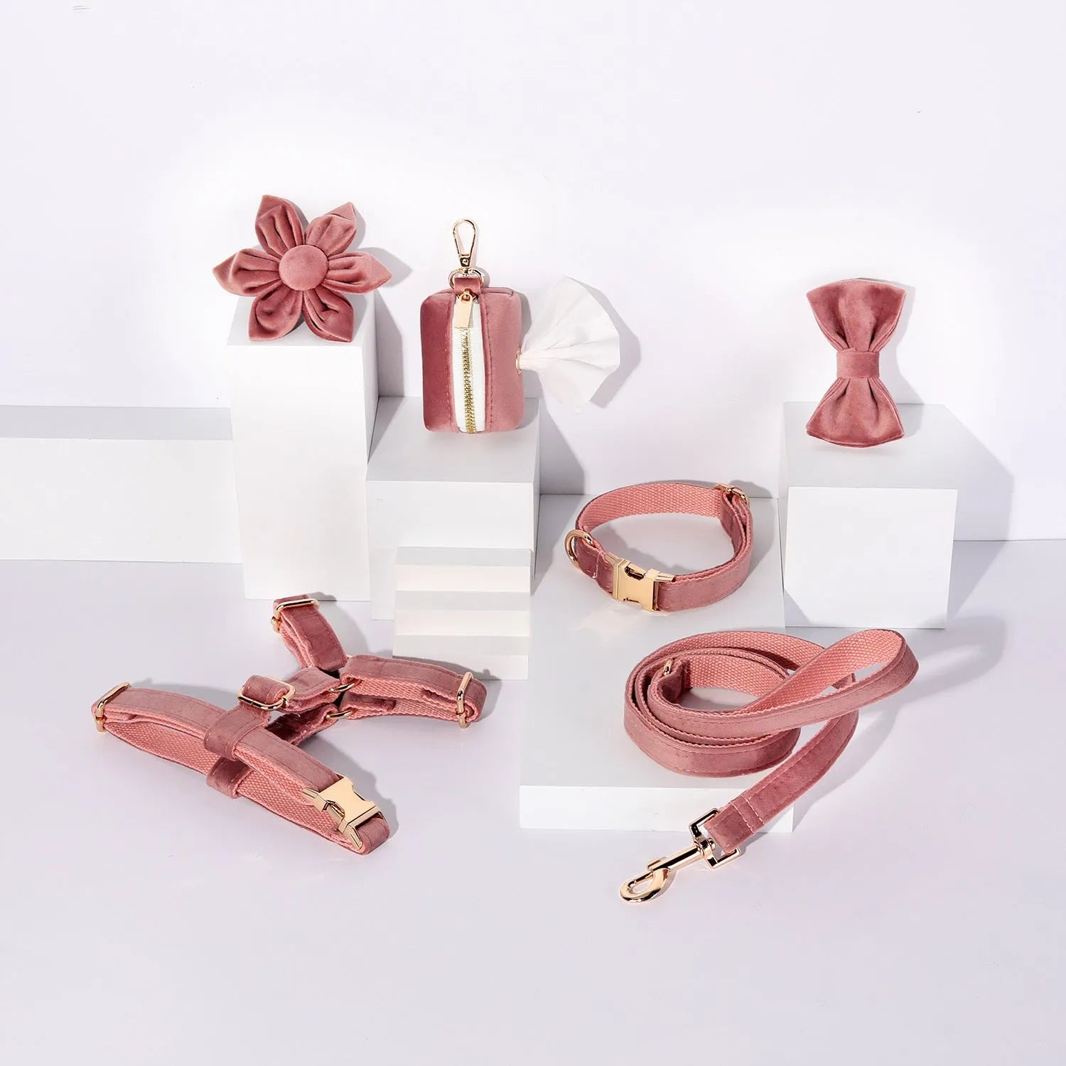 Red velvet dog collar and leash set with chest strap, bow tie, and decorative flower accessories.