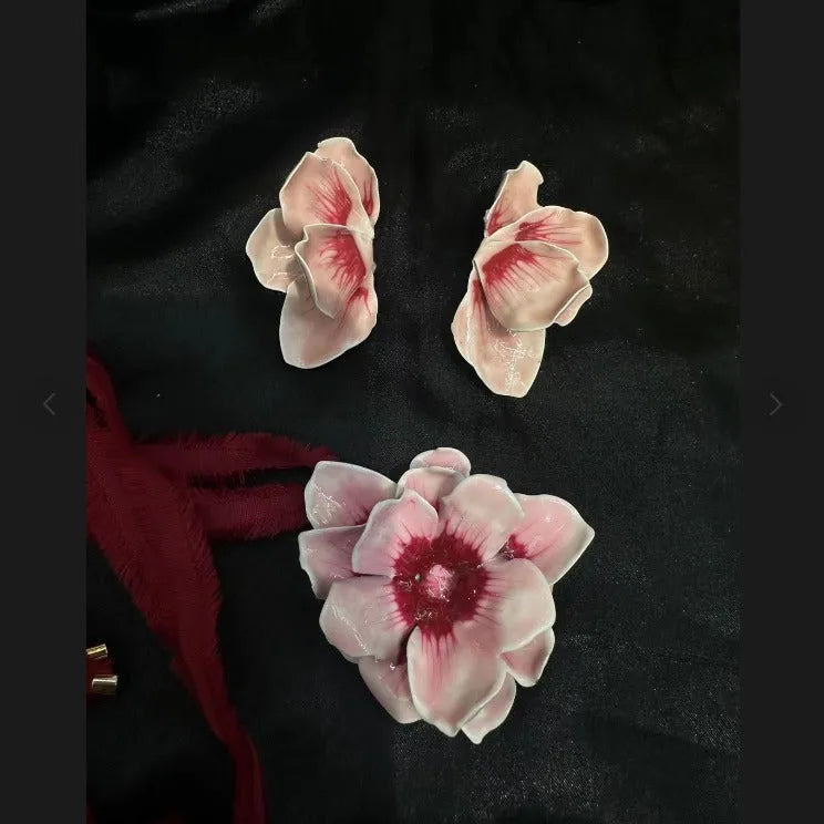 Close-up of women's alloy flower stud earrings with a blue oil-spot glaze and electroplated finish.
