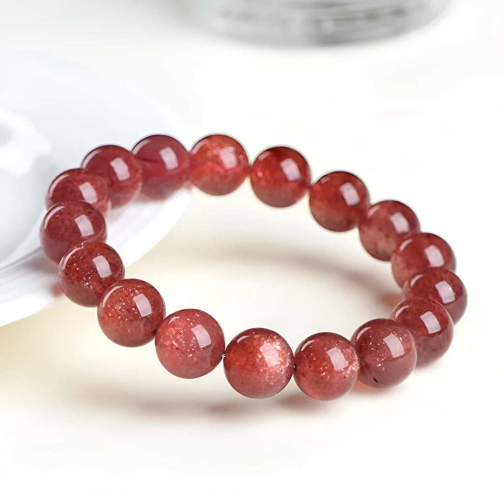A bracelet made of geometrically cut, pink strawberry quartz beads in three size options.