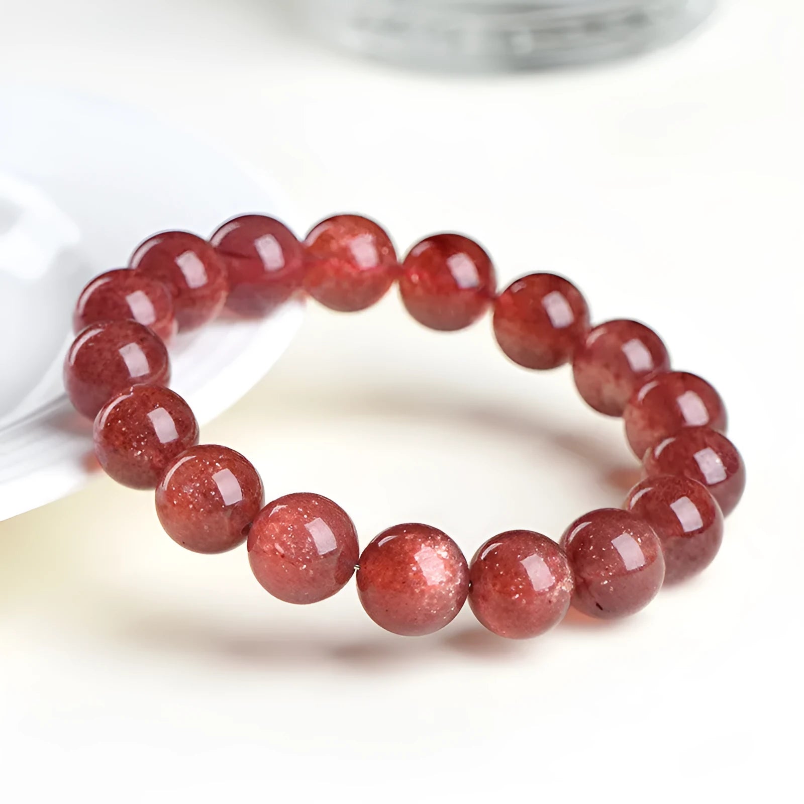 A bracelet made of geometrically cut, pink strawberry quartz beads in three size options.