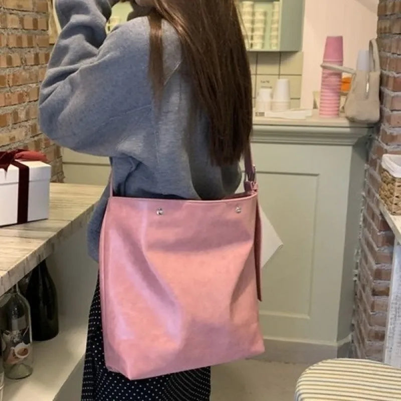 Pink or brown corduroy one-shoulder commuter bag showing dimensions.