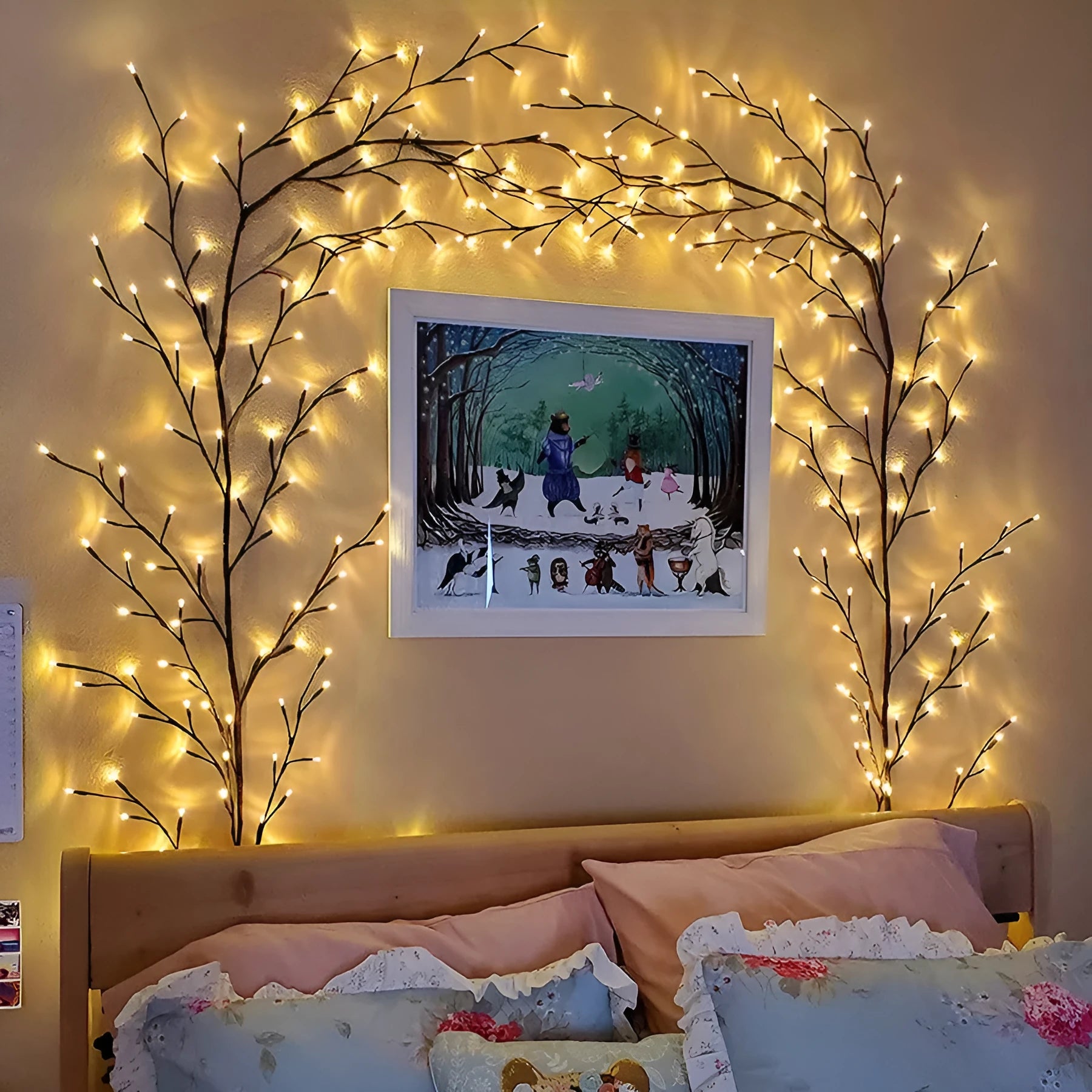 Flexible LED willow vine garland with warm white lights on birch-textured branches for wall and party decor.