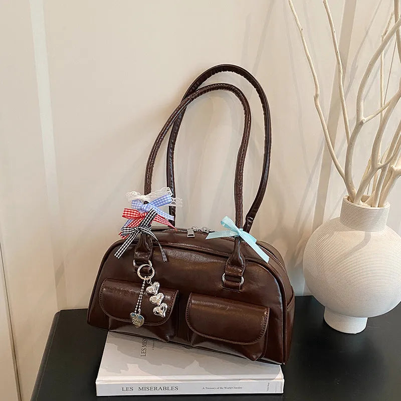 Retro pillow-shaped leather women's handbag with one shoulder underarm design in black with ribbon pendant