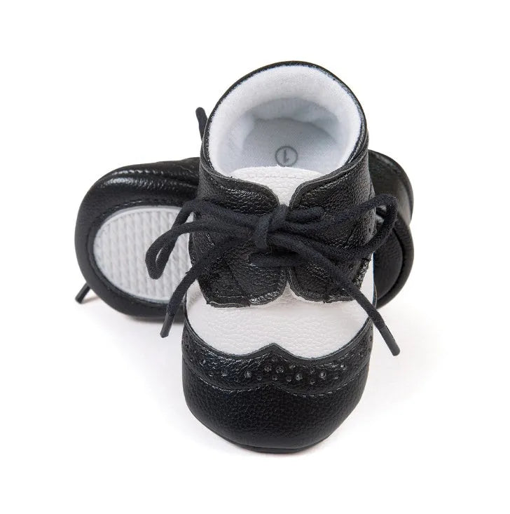 Vintage baby shoes with soft soles in light brown colour showing synthetic leather upper
