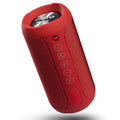 Black waterproof portable outdoor Bluetooth speaker with control buttons on top.